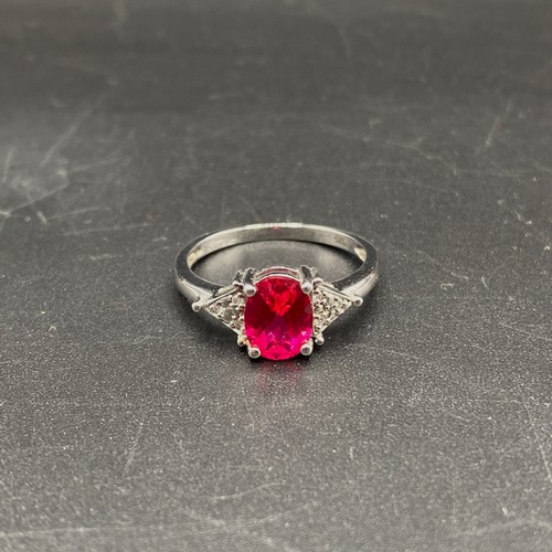 805 - 9ct White gold ring, size N. with a 1.67g Ruby with diamond shoulders. Complete with a certificate f... 