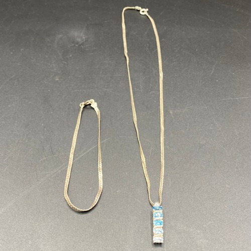 823 - Silver necklace with graded aqua marine pendant and a silver bracelet.