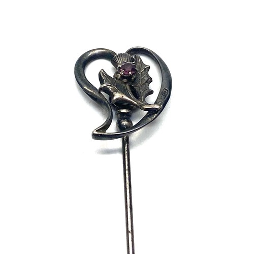 828 - Sterling silver hat pin by Charles Horner with an oscillating thistle within a heart.