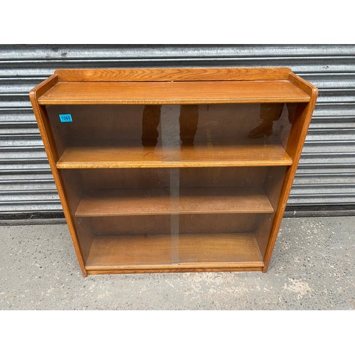 1069 - Oak glazed book case with sliding glass doors.