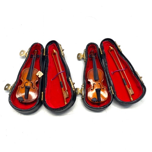 747 - 2 miniature violins with cases.