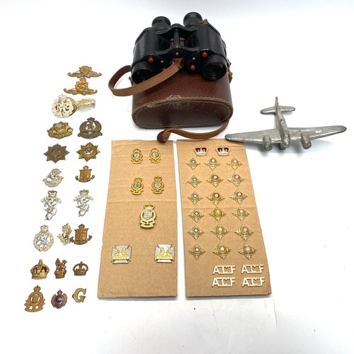 845 - Collection of militaria including: Kershaw binoculars with graticules, cap badges and shoulder ranks...
