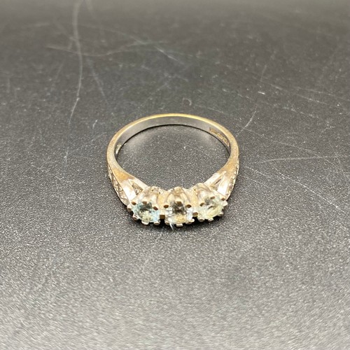 869 - 9ct gold and three diamond ring. Size N, 2.8g.