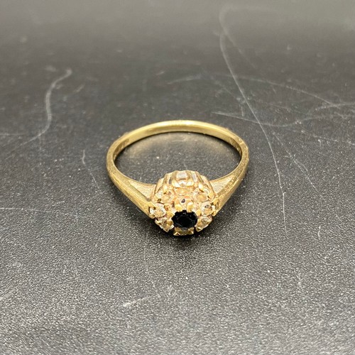 873 - 9ct gold and diamond cluster ring with a black sapphire. Size O and 2g.