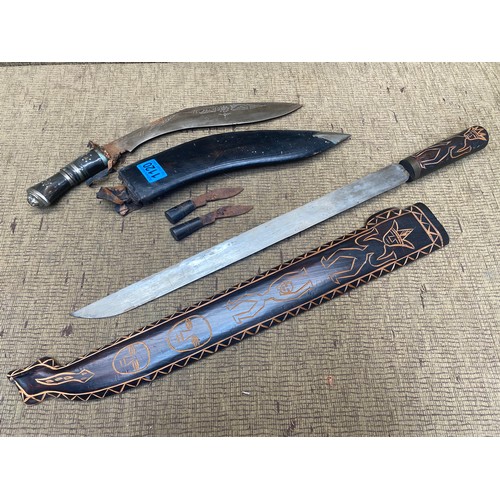 1120 - Kukri Gurkha knife and an ornamental jungle tribal sword with hand-carved hilt and sheath. Over 18 i... 