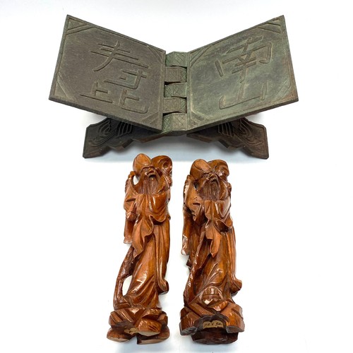 1138 - Asian treen items including: A hand carved book stand and 2 hand carved Asian men figures.