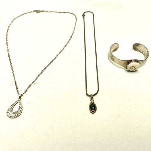 769C - Two silver pendants, two white metal chains and a Silver Shivas eye bracelet.