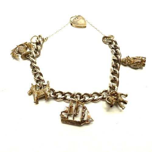 769D - Sterling Silver charm bracelet and five charms.