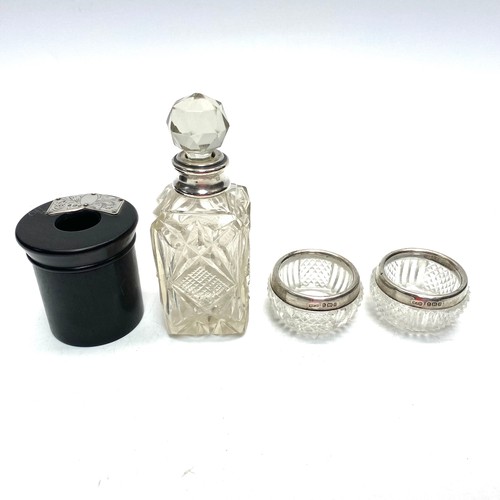 769H - Two sterling silver-rimmed salts/trinket dishes. Silver perfume bottle and ebony candle holder with ... 