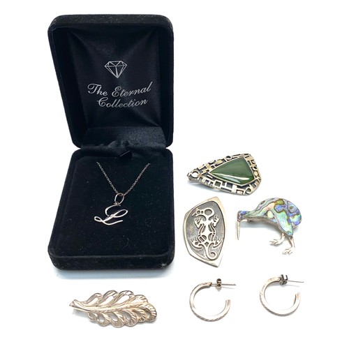 893 - Silver necklace and pendant, silver earrings, and four silver brooches.