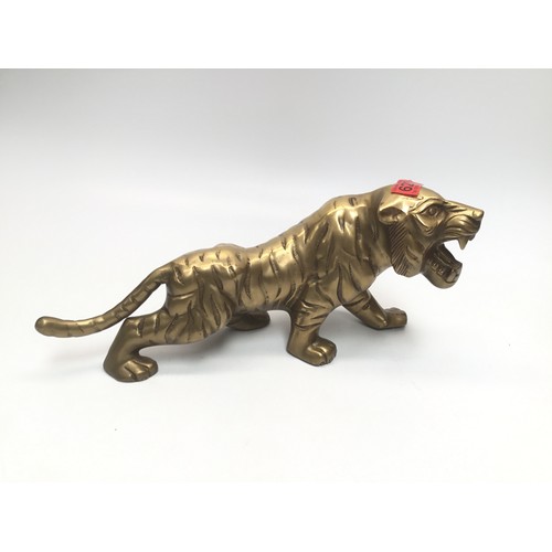 629 - Heavy brass tiger; 42cm length.