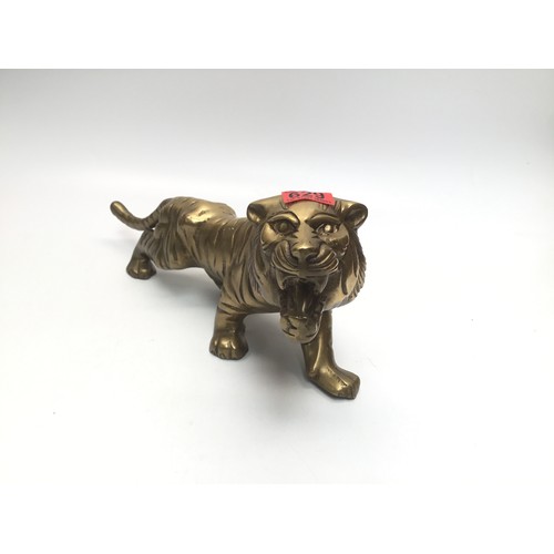 629 - Heavy brass tiger; 42cm length.