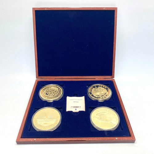 642 - Four commemorative replica coins layered in 24k gold including 1787 Brasher EB, 1898 single 9 pond a... 