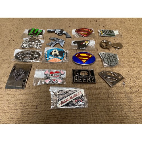 447 - Large selection of belt buckle including: Super man, Ace Of Spades and Captain America.