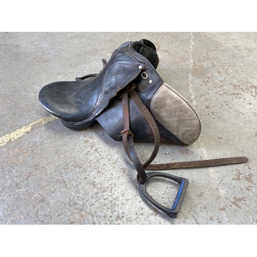 168 - Horse equipment, saddlery and saddlery making equipment including: Black leather saddle and stirrups... 