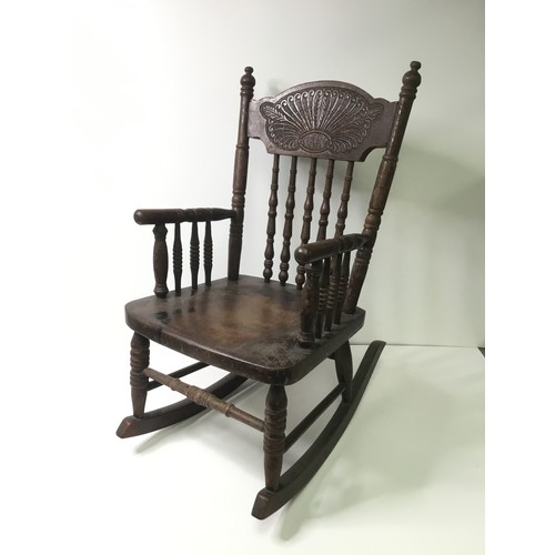 1112 - Child’s continental rocking chair with leaf decoration to back