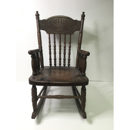 1112 - Child’s continental rocking chair with leaf decoration to back