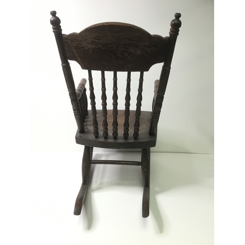 1112 - Child’s continental rocking chair with leaf decoration to back