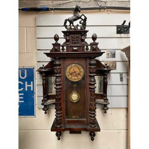 1115 - Stunning antique mahogany wall hanging clock enamel face and brass cogs with key.