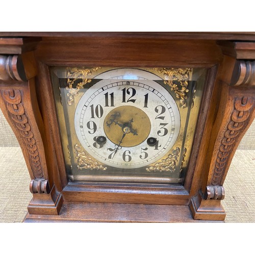 1150F - Large antique carved walnut brass face eight day bracket clock; 48cm tall.