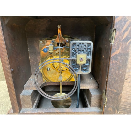 1150F - Large antique carved walnut brass face eight day bracket clock; 48cm tall.