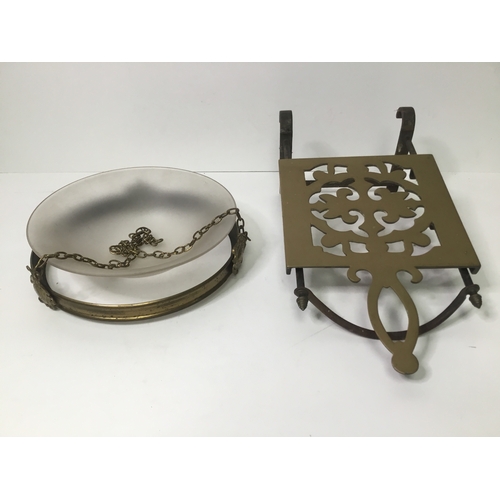 519 - Cast iron and brass kitchen trivet and a brass hanging light shade with glass