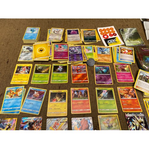 653 - Collection of pokemon cards and pokemon tins.