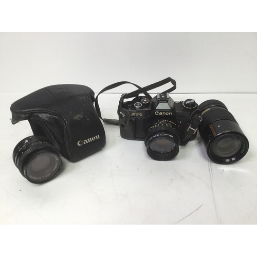 477 - Canon AV1 camera with case and two extra lenses