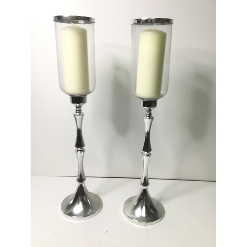 20 - A pair of chrome and glass candle stands 65cm