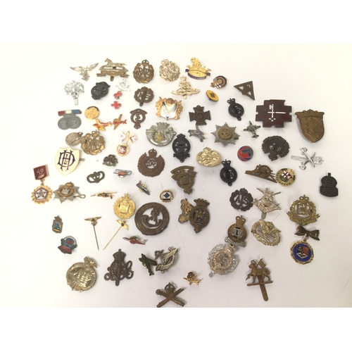 604 - A collection of approximately 70 military badges