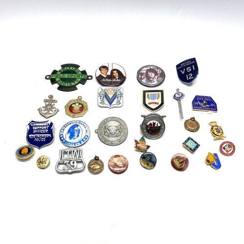 615 - Collection of badges including: John Lennon and british field sports society metal badge.