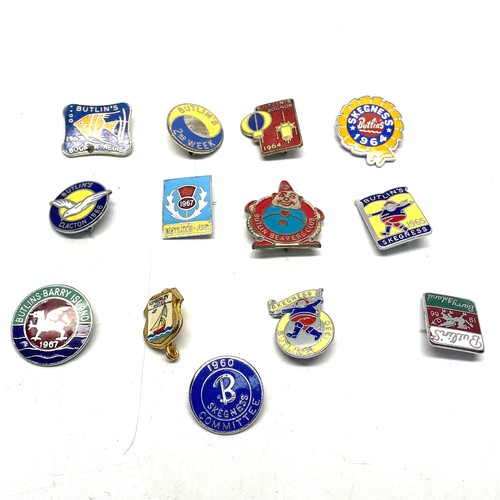 655 - 13 collectible Butlins pin badges.