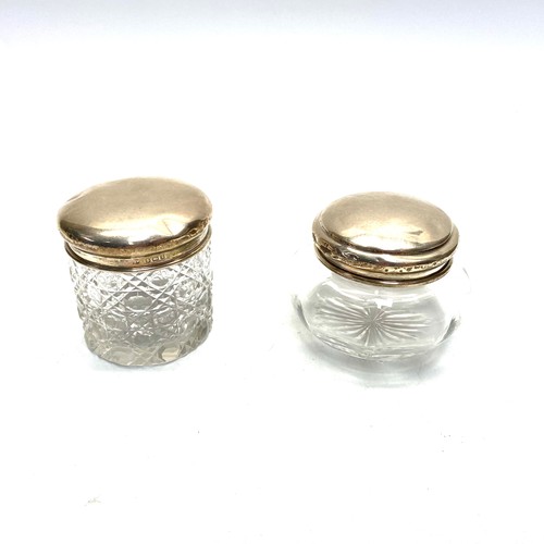 878 - Two large cut crystal and sterling silver dressing table jars 6x6cm and 5x8cm with hallmarks for Lon... 