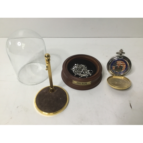 483 - John Wayne collectible pocket watch displayed on a wooden stand