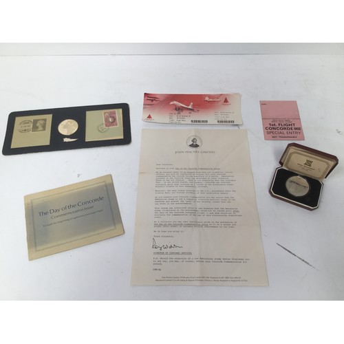 899 - Concorde memorabilia including silver first flight commemorative coin with first day cover, special ... 