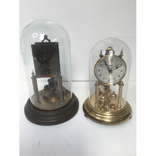 944 - Two glass domed clocks in need of repair