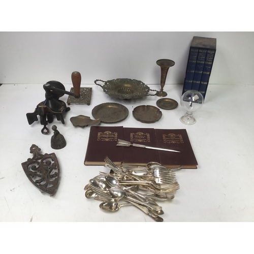 309 - Mixed items including a mincer, leather bound books and silver plate cutlery