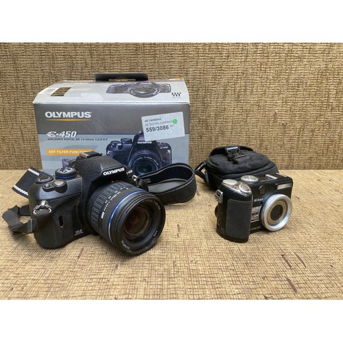 1079 - Olympus E450 with zuiko digital ED 14-42mm lens and a Nikon coolpix camera.