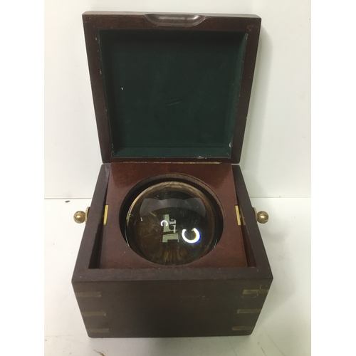 343 - Brass edged box originally would of had a ships clock in, now holds a glass ball