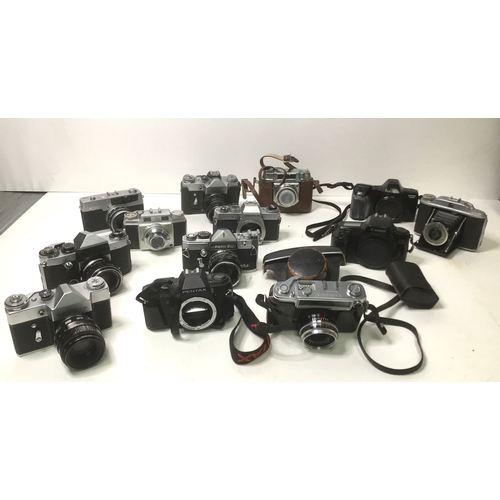 65 - A selection of vintage cameras including Pentax, Canon and Zenit