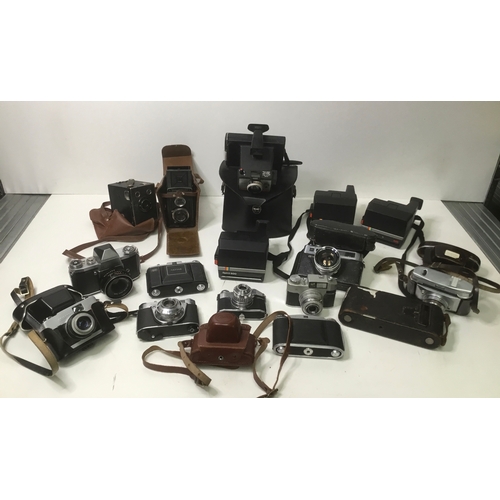 66 - A collection of vintage cameras including Polaroid, Praktica and Retinette