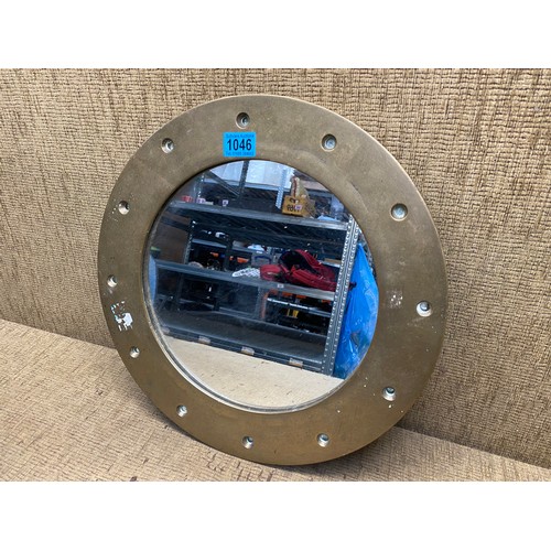 1046 - heavy brass porthole mirror 44cm.