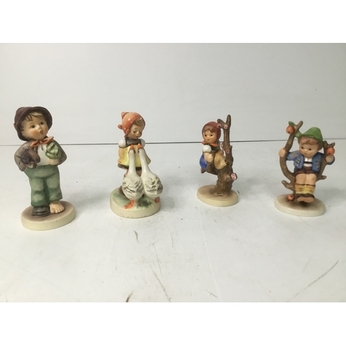 660 - Four Goebel Hummel figures including goose girl W Germany