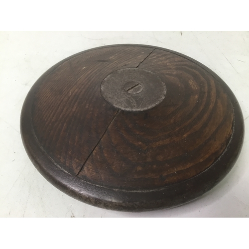 702 - An early discus from the 1930’s made from oak with a steel band