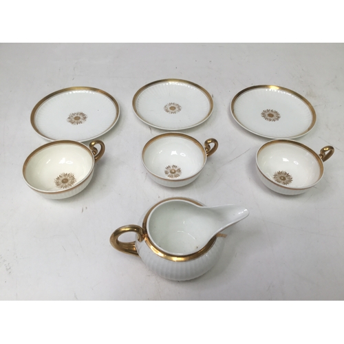 703 - A set of three Swansea porcelain Paris flute pattern tea cups with a matching cream jug