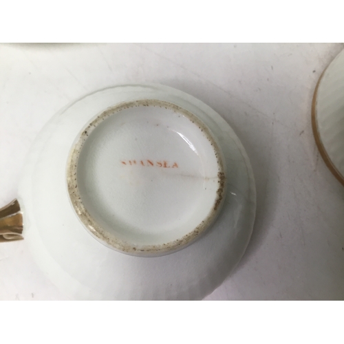 703 - A set of three Swansea porcelain Paris flute pattern tea cups with a matching cream jug