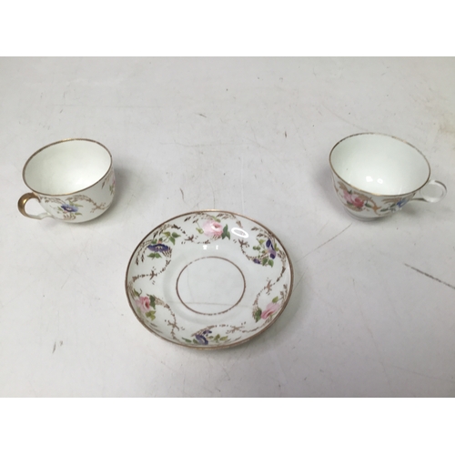 704 - A Swansea porcelain convolvulus pattern trio including a tea cup, coffee cup and a saucer