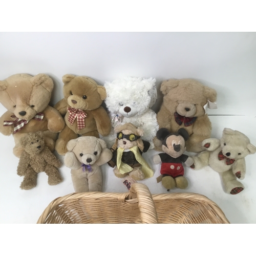 190 - A collection of teddy bears and a wicker basket