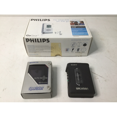 463 - Philips Go Gear portable music storage, Sony Walkman and a Sanyo sportster potable tape player