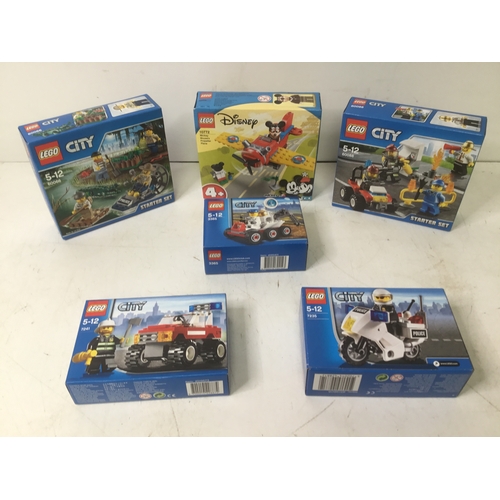 1138 - A collection of boxed Lego City and Mickey Mouse’s plane